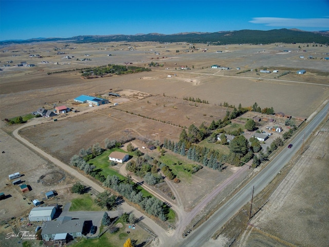 drone / aerial view featuring a rural view and a mountain view