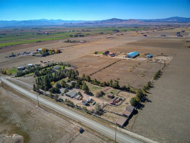 birds eye view of property featuring a mountain view and a rural view