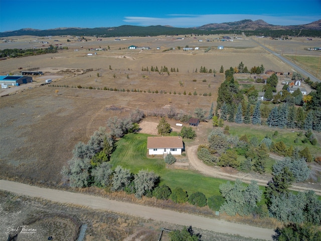 drone / aerial view with a mountain view and a rural view