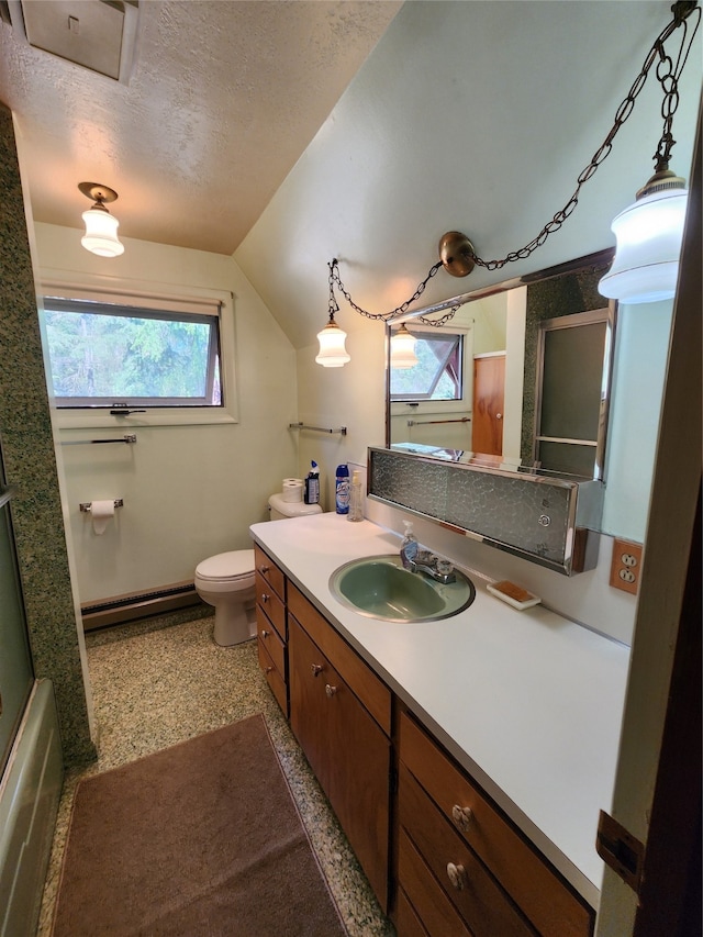 bathroom with vanity, lofted ceiling, a textured ceiling, a baseboard heating unit, and toilet