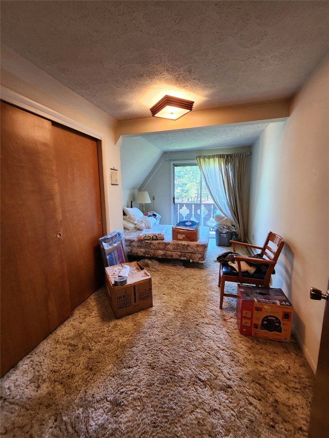 carpeted bedroom with a textured ceiling and a closet