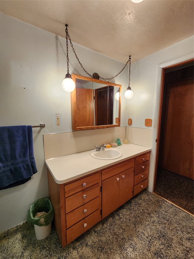 bathroom featuring a textured ceiling and vanity