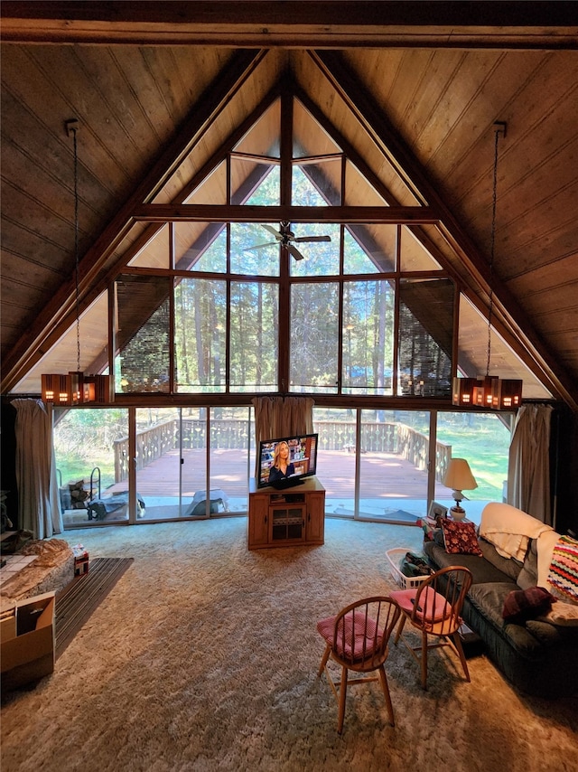 unfurnished living room featuring vaulted ceiling with beams, carpet, and wood ceiling