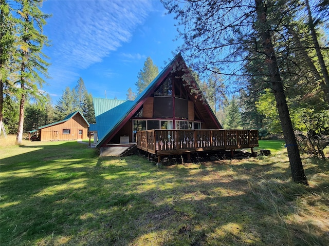 back of property featuring a yard and a wooden deck