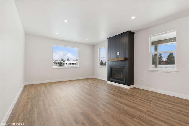 unfurnished living room with a fireplace and wood-type flooring