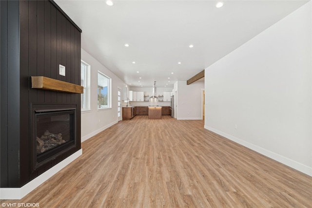 unfurnished living room with light hardwood / wood-style floors and a fireplace