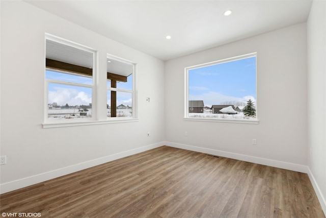 unfurnished room featuring hardwood / wood-style flooring