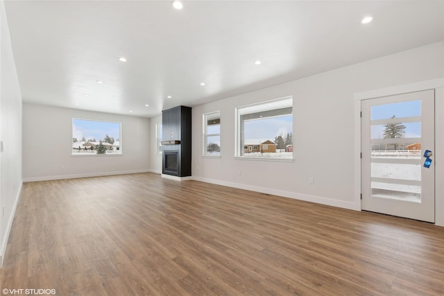 unfurnished living room with dark hardwood / wood-style flooring