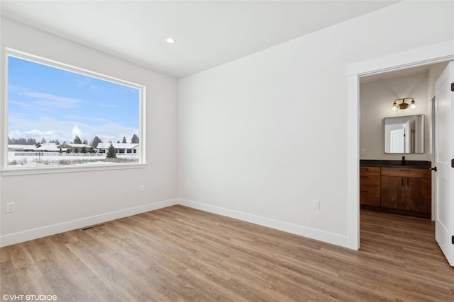 spare room featuring light hardwood / wood-style flooring