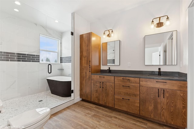 full bathroom with toilet, vanity, plus walk in shower, and hardwood / wood-style floors