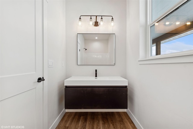 bathroom featuring vanity, a shower, and hardwood / wood-style flooring