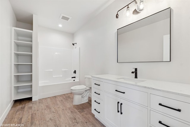 full bathroom featuring toilet, vanity, bathing tub / shower combination, and hardwood / wood-style flooring