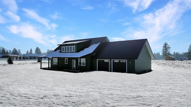 view of snow covered back of property