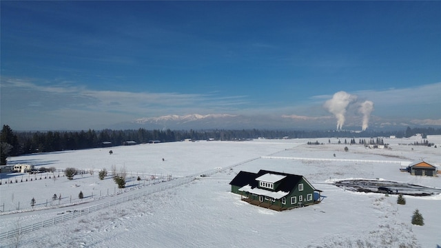 yard covered in snow featuring a rural view