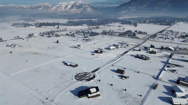 snowy aerial view with a mountain view