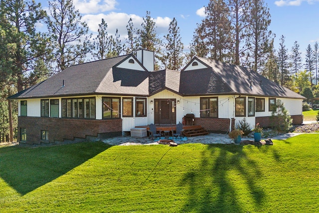 ranch-style home with a front lawn and a sunroom