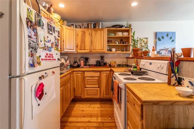 kitchen with white appliances, wood counters, light hardwood / wood-style flooring, and light brown cabinets