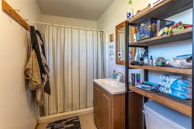 bathroom with tile patterned flooring, vanity, a shower with shower curtain, and toilet