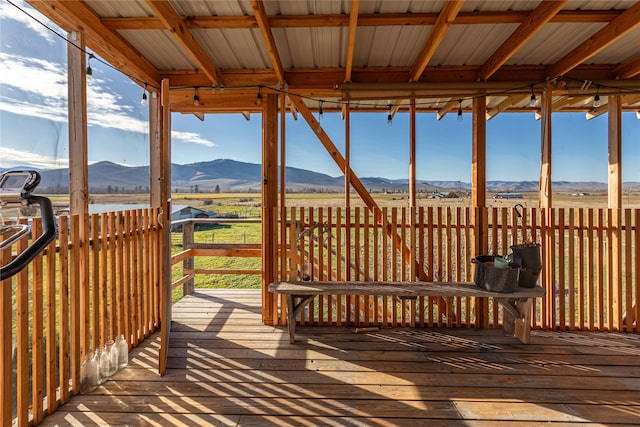 wooden deck with a rural view and a mountain view