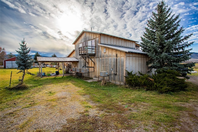 view of side of home featuring a yard