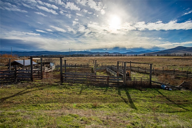 view of yard with a rural view and a mountain view