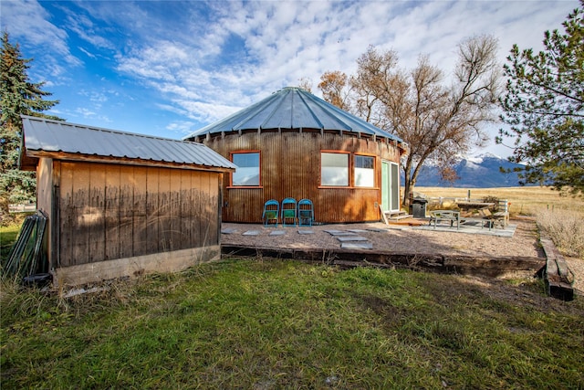 view of outbuilding with a mountain view and a yard