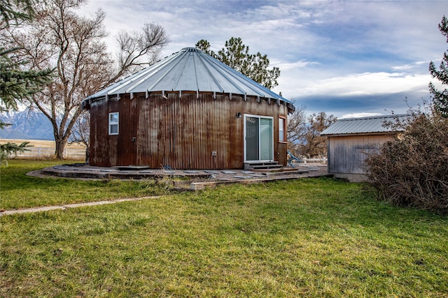 view of outbuilding with a lawn