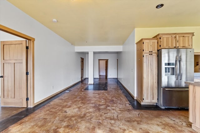 kitchen featuring stainless steel refrigerator with ice dispenser and light brown cabinets