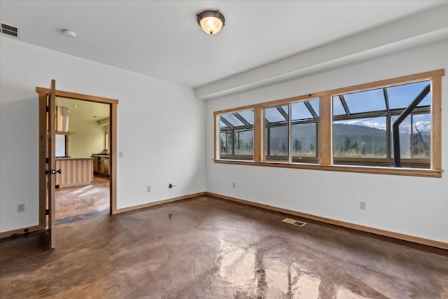 unfurnished room featuring concrete floors