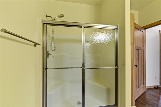 169 Brookes Dr, Rexford, MT 59930 - full bathroom featuring an enclosed shower and wood finished floors