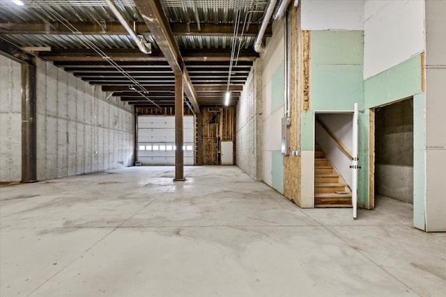 miscellaneous room featuring concrete flooring and electric panel