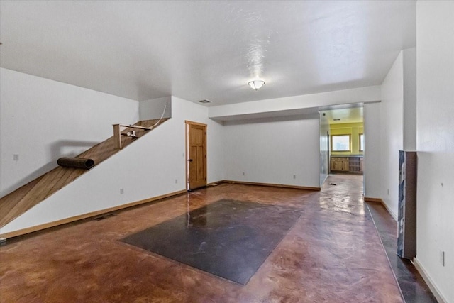169 Brookes Dr, Rexford, MT 59930 - unfurnished living room featuring concrete flooring and baseboards
