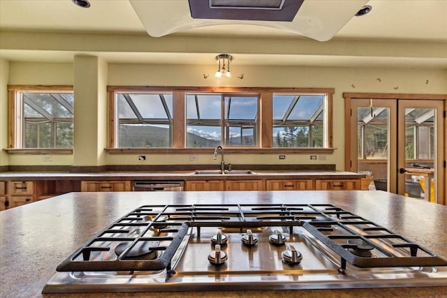 169 Brookes Dr, Rexford, MT 59930 - kitchen with brown cabinetry, appliances with stainless steel finishes, dark countertops, and healthy amount of natural light