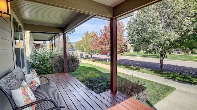 wooden terrace with a yard