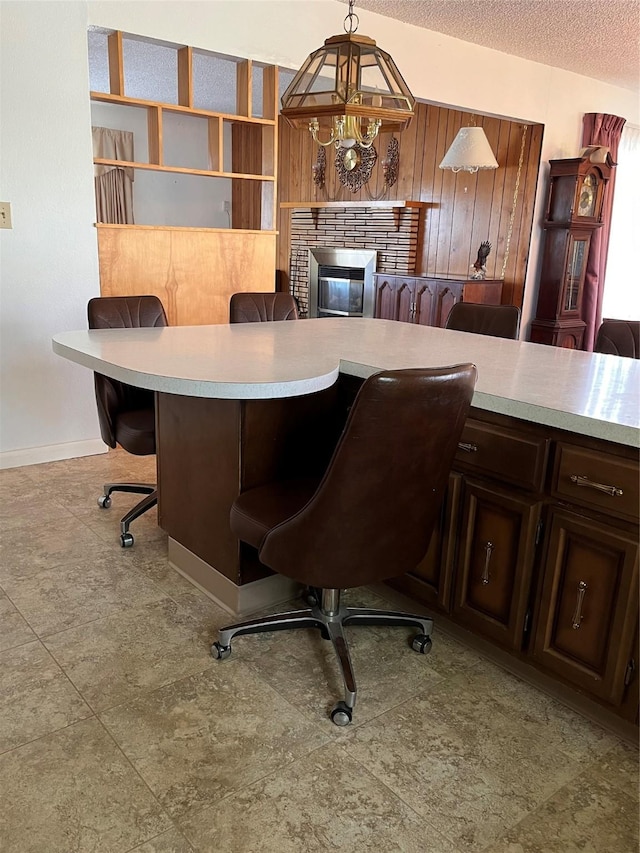 233 4th Ave SW, Cut Bank, MT 59427 - office area featuring a brick fireplace, a textured ceiling, and wooden walls