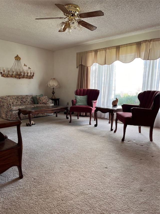 carpeted living room with a textured ceiling and ceiling fan