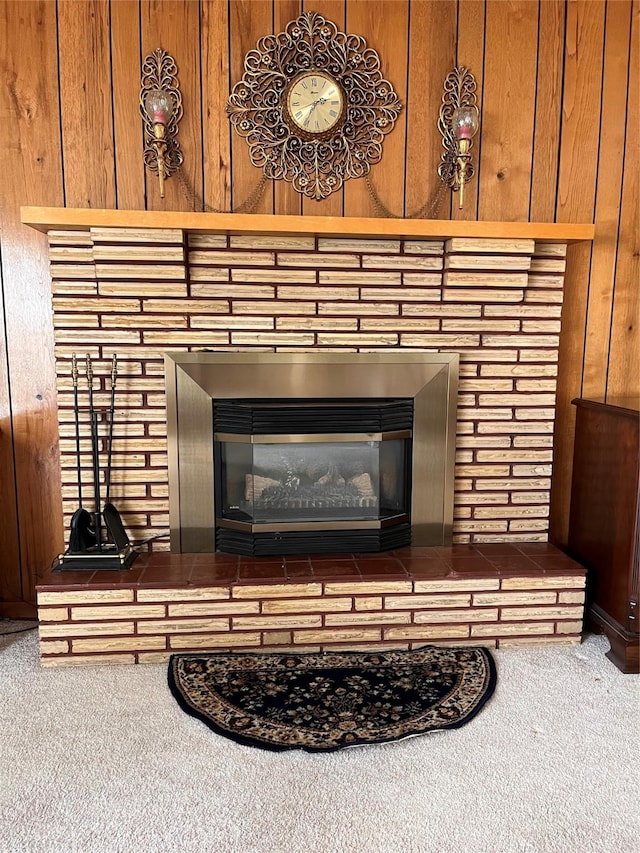 233 4th Ave SW, Cut Bank, MT 59427 - detailed view of a brick fireplace, carpet flooring, and wooden walls