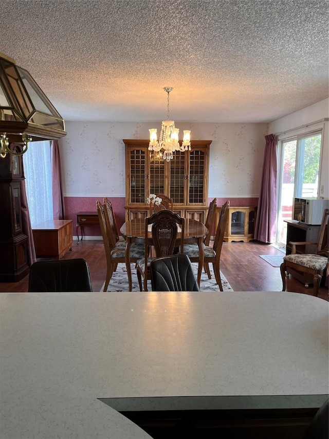 233 4th Ave SW, Cut Bank, MT 59427 - dining space with wallpapered walls, a chandelier, a wainscoted wall, a textured ceiling, and cooling unit