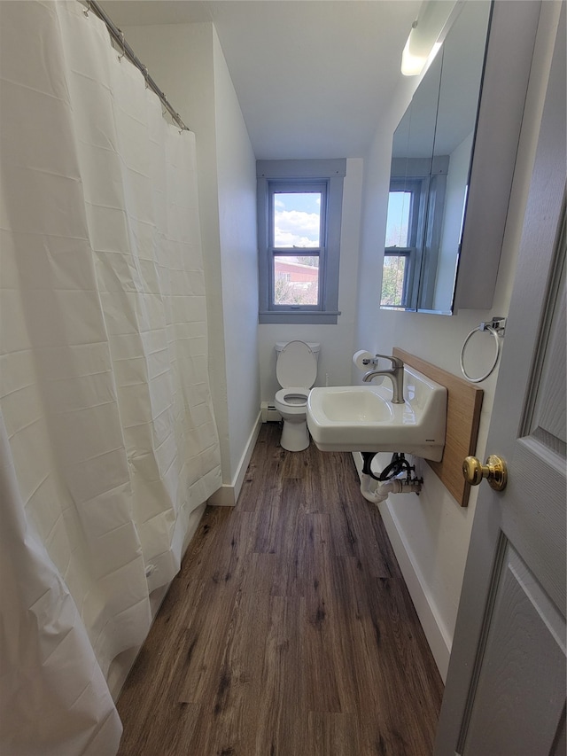 bathroom with walk in shower, toilet, sink, and hardwood / wood-style flooring