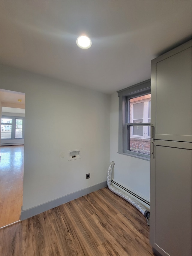 laundry room featuring a baseboard radiator, wood-type flooring, electric dryer hookup, and washer hookup