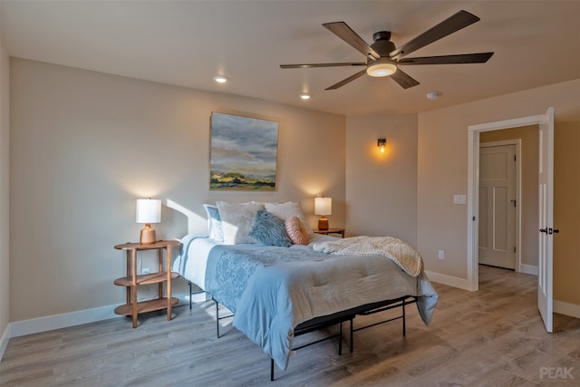 bedroom with ceiling fan and light hardwood / wood-style floors