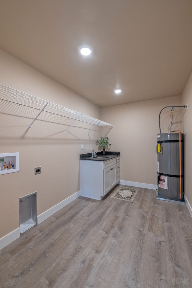 laundry area featuring hookup for a washing machine, sink, hookup for an electric dryer, light hardwood / wood-style floors, and gas water heater