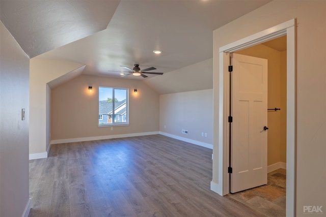 bonus room featuring lofted ceiling, light hardwood / wood-style flooring, and ceiling fan