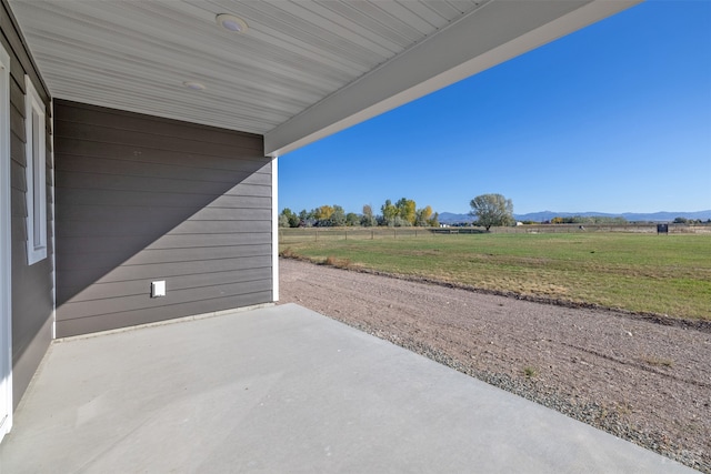 view of patio with a mountain view and a rural view