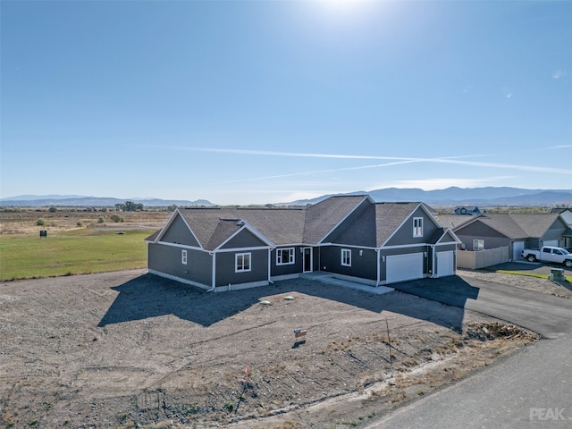 view of front of property featuring a garage and a mountain view