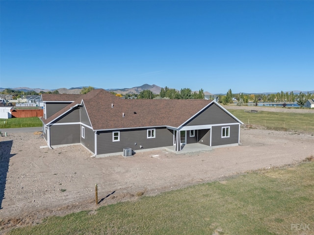 rear view of property with a mountain view and cooling unit