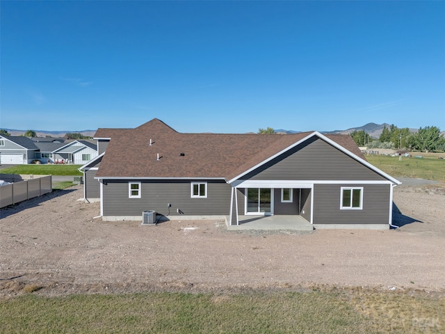 back of house with central air condition unit, a mountain view, and a patio