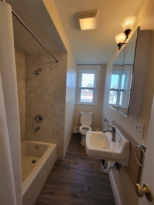 full bathroom featuring sink, wood-type flooring, shower / bathtub combination with curtain, a baseboard radiator, and toilet