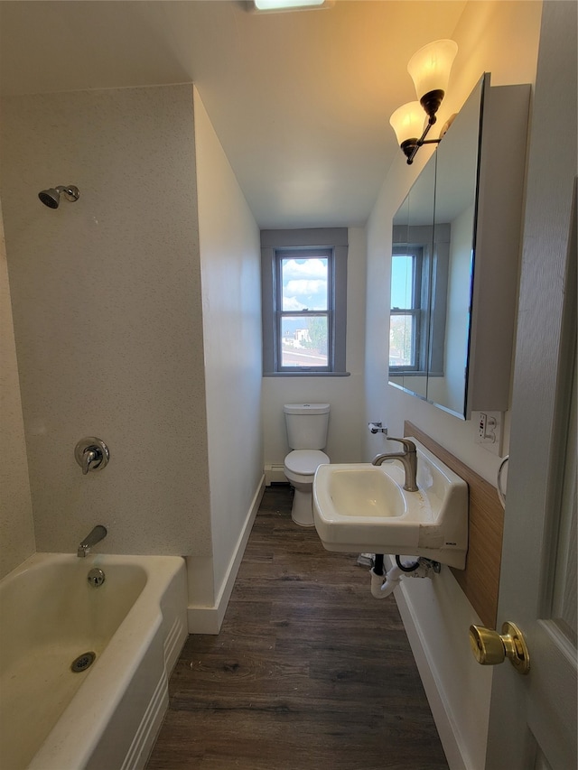 bathroom featuring wood-type flooring, toilet, and sink