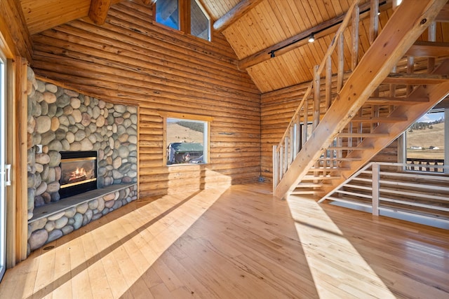 unfurnished living room with high vaulted ceiling, a fireplace, wooden ceiling, wood-type flooring, and track lighting